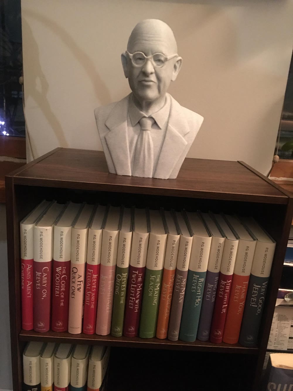 Buyer-submitted portrait bust displayed above a collection of books