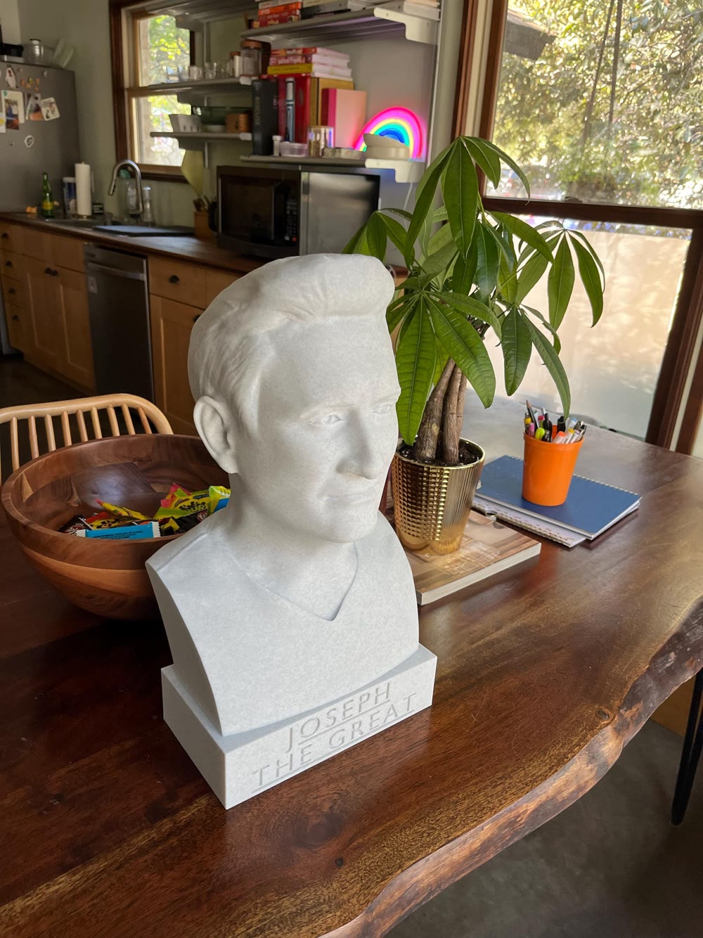 Buyer-submitted ivory portrait bust displayed on a wooden table at home