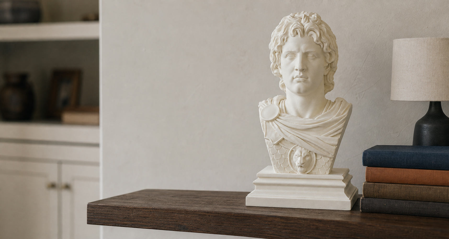Ivory Alexander the Great bust displayed on a dark wood shelf in a quiet home study